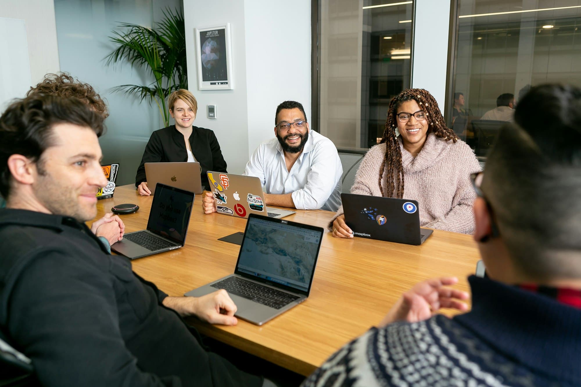 A team working on laptops during a meeting