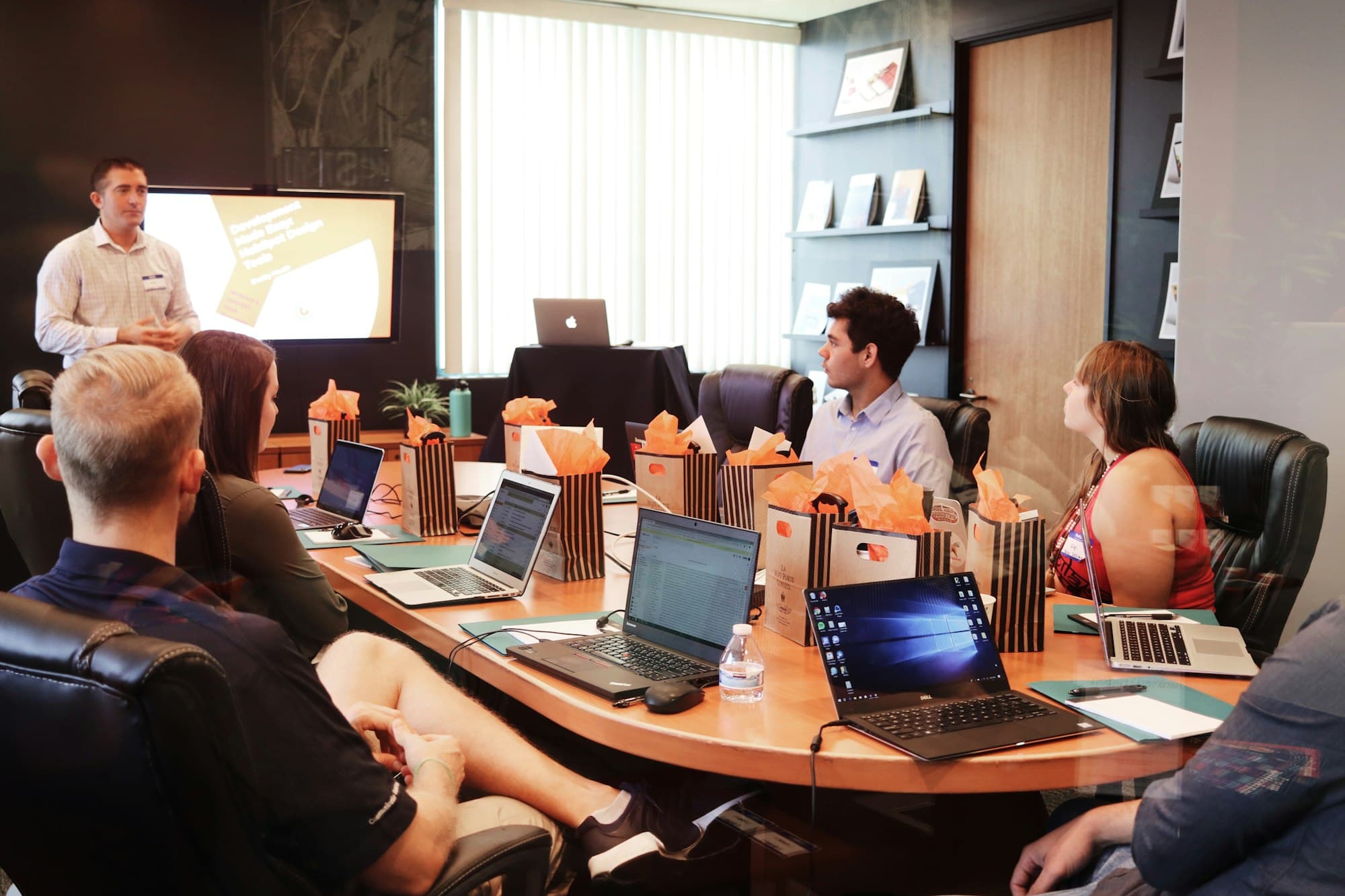 A leader presenting to a team around a table